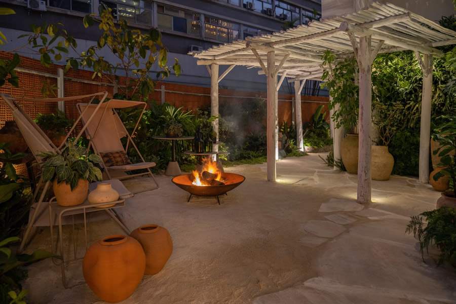 Jardim Sereno &ndash; Ambiente de Gabi Pileggi e Luciana Bacheschi na CASACOR SP 2023. O fogo de ch&atilde;o no centro e o pergolado constru&iacute;do com biribas de eucalipto est&atilde;o entre os destaques do espa&ccedil;o / Foto de Cac&aacute; Bratke