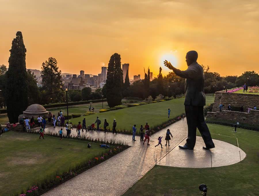 People walking around the Nelson Mandela statue at the Union Buildings_VisitSouthAfrica